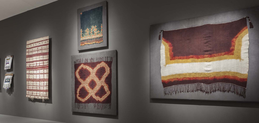 Gallery installation of 'Majestic African Textiles' at Indianapolis Museum of Art showing Zulu beadwork far left and Moroccan and Tunisian tie-dyed shawls 