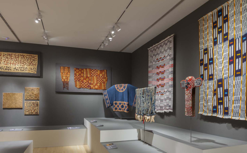 Gallery installation of 'Majestic African Textiles' at Indianapolis Museum of Art showing Central African raffia weaving, Dida plant fibre skirts and Yoruba beadwork 
