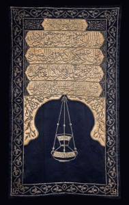 Sitarah for the minbar of the Meccan Sanctuary, with the name of King Faruq of Egypt Cairo, dated AH 1365 (1946 AD); dark-blue silk, with beige silk appliqués, embroidered in silver and silver-gilt wire over padding, 212 x 125 cm