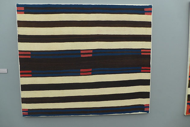 Perhaps the best of three Navajo native American blankets hung as a ...