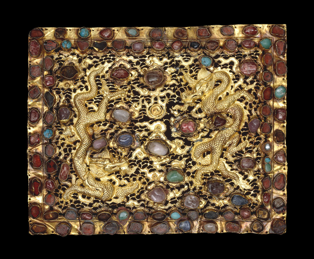 A pair of gold pillow ends, decorated with two dragons and worked in relief with chased detail and openwork. Gold, rubies, turquoise and other precious and semi-precious stones, Beijing or Nanjing, Xuande era, 1426-1435. © The Trustees of the British Museum
