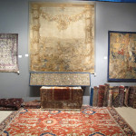 Aaron Nejad, London, stand showing a 19th century French tapestry fragment above a fine all-over design Heriz on stand