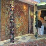 Gideon Hatch mixes rugs of his own design with antique rugs including a 19th century Heriz on his stand at HALI at Olympia
