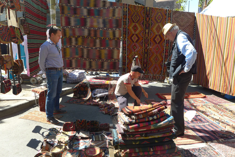 Ben Evans and Paul Ramsey look at rugs and fragments on offer in the Vernissage Market, Yerevan, Armenia