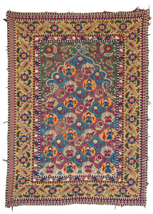 Azerbaijan Embroidery, Azerbaijan, first Half 19th century, 175 x 127 cm (5ft. 9in. x 4ft. 2in.); silk on cotton. Austrian Auctions, Vienna, 22 April, Lot: 95. Estimate: € 8.000 – 12.000. Silk embroideries from the southern Caucasus/Azerbaijan fall into two principle groups. The first, often related to rug designs like Dragon carpets, usually relatively abstract in style and done in cross stich and the second more floral, naturalistic and often depicting people and animals sewn using darning stitch. This example uses darning stitch and shows seated figures and peacocks meaning that it belongs to the second group which is in general more closely related to Iranian art. There seem to be fewer examples of this group published, many of which have designs containing mihrabs drawn in a distinct style. The design of the inner part of the mihrab in this piece is relatively unusual, since most examples with prayer arches show tree of life designs or flowers in vases. Other examples show medallions like in Lot 63 Christies 24.4.12, which has main and minor borders nearly identical to this example. Every flower in the main border has the same floral motif as the appears in the tail of the peacocks that surround the seated figures in the field. The black and white/yellow blocks in the outer and inner frame seem to be a feature of almost all examples of the darning stitch group.