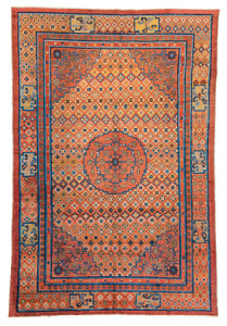 Khotan Silk, Eastern Turkestan, first half 19th century. 270 x 184 cm (8ft. 10in. x 6ft.; Warp: silk, weft: silk, pile: silk. Lot: 147, Austrian Auctions, Vienna, 22 April, Lot: 212,Estimate: € 30.000 – 40.000. This silk carpet has a certain Tibetan feel to it. Although it probably was not made in Tibet it may have been intended for export to the region but made in one of the neighbouring carpet producing centres in the oasis towns of eastern-Turkestan in the north or Gansu province in the east. The use of silk and its structure point towards Yarkand or Khotan while the design of the rug and the colours point more towards Gansu. The main border, the ‘Buddhist pearl’ minor border and the field show strong links to China, while the reciprocal other minor border is typical for Gansu. Note also that the ‘endless knot’ symbols in the corner of the same border. Only the decoration in the medallion and the corners could be considered to be east-Turkestan motives; the lack of any of the golden yellow typical of the region and the use of a different shade of red would further the argument that this is in fact a rug made in the Gansu. That having been said, Hans König noted in his seminal article about Gansu carpets in Hali 128 that he didn’t know any silk rugs from the area.