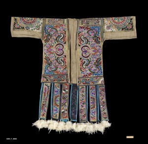 Robe China Miao, early 20th-Mid 20th Century. 4' 7" x 4' 1" (139.7 x 124.5cm); Cotton, pulped silk, silk and cotton thread. seed beads, feathers. Hundred Bird Jacket. Elaborate front opening, full sleeved, collared, calf-length robe with multiple hanging lapets decorated with embroidery, beads and feathers at bottom. Ground surface of pulped silk, embroidery thread from carded and spun silk thread. Roger Hollander Collection - Primary collection