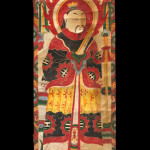 Banner, China Yao, Late 19th-Early 20th Century. 1' 7" x 4' 3" (48.3 x 129.5cm); Tempera painting on handmade paper. Scroll form banner on handmade paper with sticks of bamboo securing ends. Tempera painting of a haloed central figure holding a scroll, and wearing an elaborate robe, birds and a canopy decorating the top section. Roger Hollander Collection - Primary collection