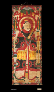 Banner, China Yao, Late 19th-Early 20th Century. 1' 7" x 4' 3" (48.3 x 129.5cm); Tempera painting on handmade paper. Scroll form banner on handmade paper with sticks of bamboo securing ends. Tempera painting of a haloed central figure holding a scroll, and wearing an elaborate robe, birds and a canopy decorating the top section. Roger Hollander Collection - Primary collection