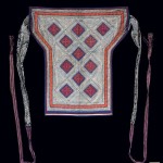 Baby Carrier, China Geija, mid 20th century. 2' 4 1/2" x 2' 6 1/2" (72.4 x 77.5cm); other (with ties): 196cm (6' 5 1/8"); Cotton cloth, silk thread; embroidery, applique, wax resist. A complete baby carrier with embroidered wax resist (batik) central panel with applique and an embroidered border. Long cloth ties with purple and white supplementary warp float and wax resist (batik) sections. Roger Hollander collection - Primary collection