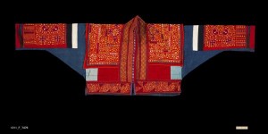 Jacket, China Yi, early 20th-mid 20th century. Cotton, silver; silk and cotton embroidery; Cuff to cuff and collar to hem: 3' 10 1/2" x 1' 3" (118.1 x 38.1cm). Short jacket with side loop closure, composed of varied panels of plain tabby woven cotton, silk and cotton embroidery on cotton. Breast and back ornamented with sewn-on plaques of repousse silver in conical form. Roger Hollander Collection - Primary collection