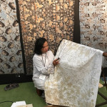 Batik artist using wax resist on cotton batik - part of the display of exhibition of Indonesian textiles from The Jakarta Textile Museum organised at The fair by Curtis and Margaret Keith Clemson