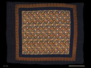 Blanket, China Zhuang, Early 20th Century. 4' 2" x 5' 3" (127 x 160cm); Cotton tabby fabric, bast fiber, brass buttons; embroidery. Blanket with a large center panel with weft inlay or embroidery on bast fiber ground, three borders of cotton tabby cloth, loop and button closure between inner and outer borders on all sides.Roger Hollander Collection - Primary collection