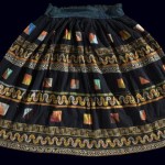 Skirt, China Yi, Early 20th-Mid 20th Century. Closed hem width by waistband to hem: 5' x 3' 3" (152.4 x 99.1cm); Cotton, silk, foil; appliqué, embroidery, couching. A full, gathered closed skirt with a wide waistband, decorated in horizontal stripes of batik, combined applique and embroidery, silk ribbon, and couched foil. Roger Hollander Collection - Primary collection