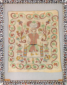AN EMBROIDERED FIGURAL TEXTILE FRAGMENT
